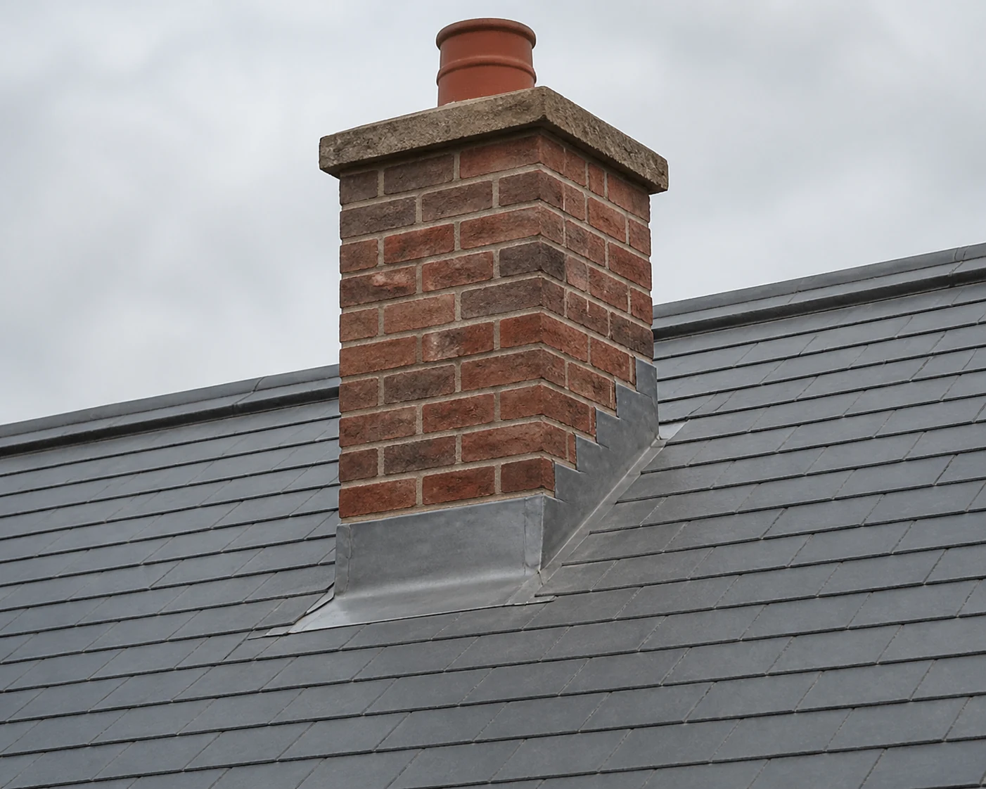 Neatly fitted lead flashing protecting a chimney base